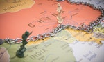 India and China borders symbolic photo with miniature soldier and a chain on borders world map