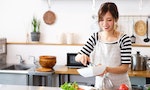 Asian housewife cooking in the kitchen