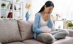 Sad and stressed pregnant woman. asian young female lady at home depressed not ready to be mom sitting on couch sofa at home. beautiful upset girl cover face by hands having problem parenthood