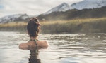 Girl in a hot spring in Iceland Landmannalaugar