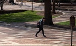 Raleigh, NC/United States- 03/18/2020: A single student walks across the mostly deserted campus of NC State which cancelled face to face classes amid the coronavirus epidemic.