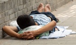 Beijing / China - June 21, 2015: Poor homeless man lying in the street, Beijing, China