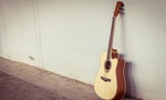 acoustic guitar on gray wall background with shadow edge.vintage tone.