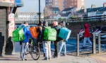 London, United Kingdom, January 04, 2021: Day food delivery. Couriers of fast food, backpack behind his back delivers food from cafes and restaurants do to national lockdown (coronavirus covid-19)