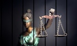Lady Justice against jail background