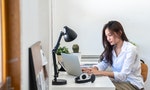 Young beautiful Asian business woman using laptop computer with internet for working from home. Attractive girl creative freelance typing on laptop for online chat remote meeting with the customer.