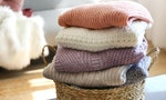 pile-of-knitted-sweaters-of-different-co